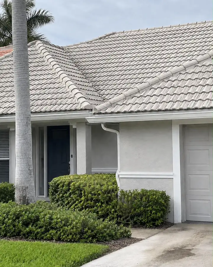 The same concrete tile roof after cleaning, an even pale grey again.