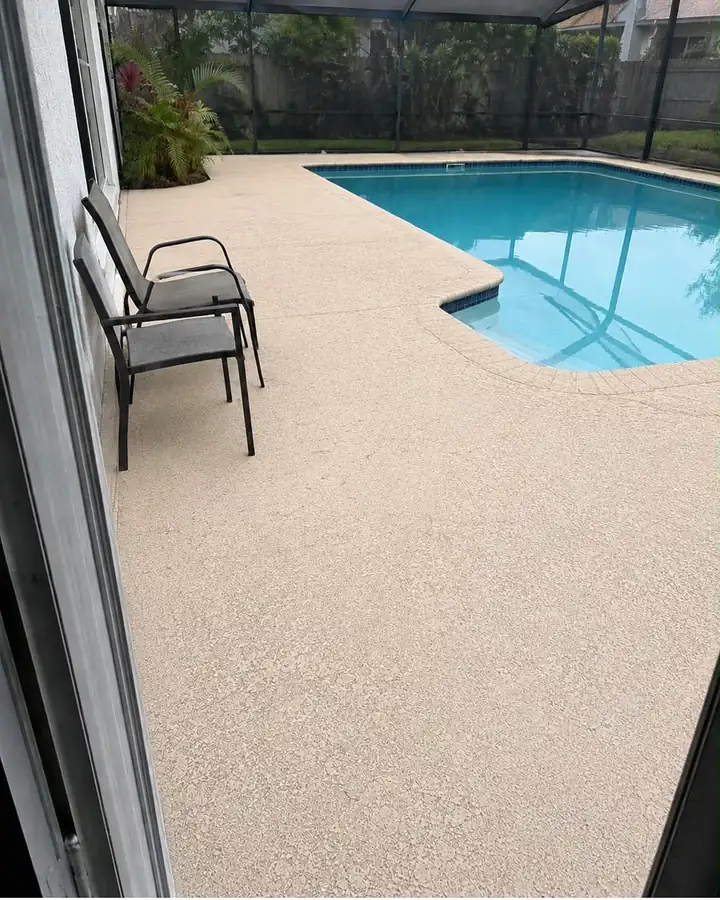The same pool deck after pressure cleaning, an even sand color.